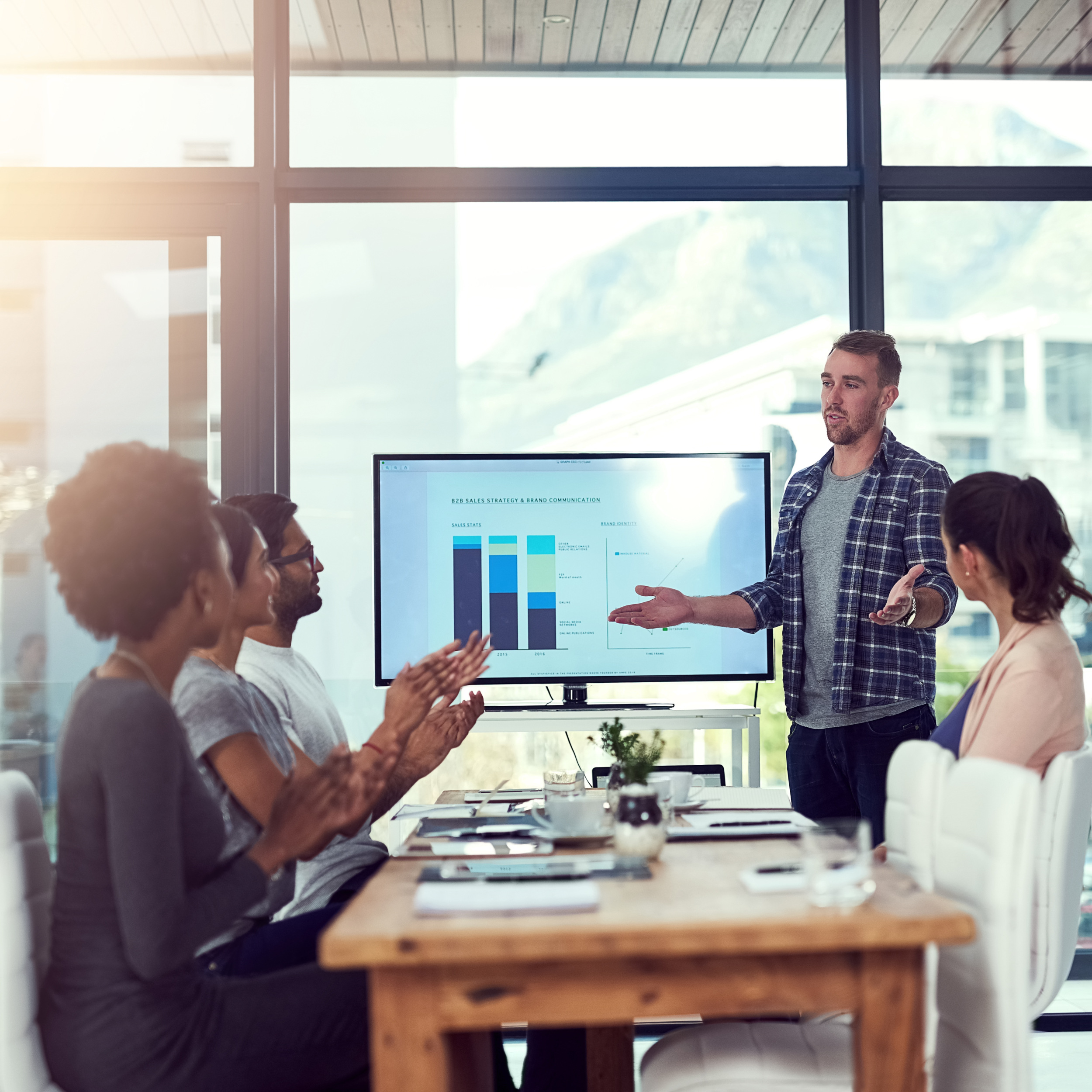 A professional presenter showing SEO performance growth charts to a team, highlighting successful SEO Company in Houston.